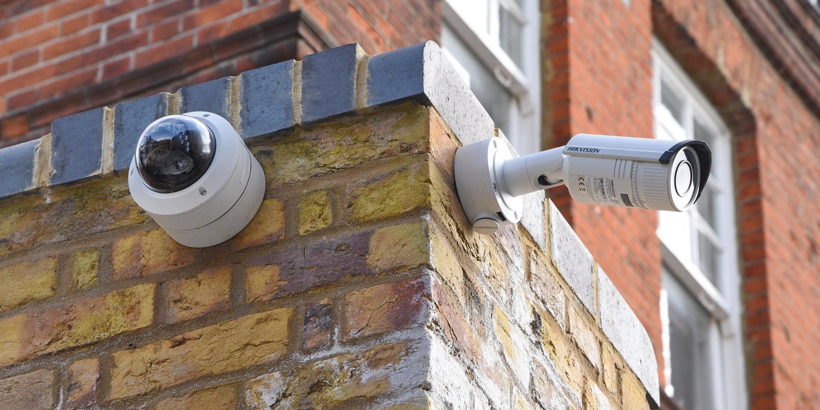Dome and bullet cameras fitted to a brick corner